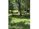 Scenic view of the property's grassy and wooded area with a small pond at 9168 S State Road 9, Flat Rock, IN 47234