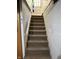 Carpeted steps leading to a bright area with a secure handrail at 9168 S State Road 9, Flat Rock, IN 47234