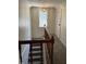 Stairway with carpeted steps, wooden railing and a window allowing for natural light at 9168 S State Road 9, Flat Rock, IN 47234