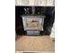 Close-up of modern wood burning stove with blower and brick surround at 9168 S State Road 9, Flat Rock, IN 47234