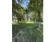 View of backyard and house through mature trees at 9168 S State Road 9, Flat Rock, IN 47234