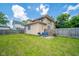 Spacious backyard featuring a small patio area with outdoor seating and a barbecue grill at 917 W 8Th St, Anderson, IN 46016