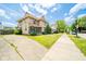 A charming two-story home is showcased from the sidewalk, displaying its well-kept lawn and neighborhood charm at 917 W 8Th St, Anderson, IN 46016
