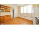 A kitchen awaits personal touches with wood cabinets and a window at 917 W 8Th St, Anderson, IN 46016