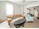 Spacious living room featuring a comfortable sofa and views into the adjacent room at 917 W 8Th St, Anderson, IN 46016