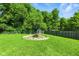 The backyard features a lush lawn, a firepit, and a shed for extra storage at 9265 Brunson Run, Indianapolis, IN 46256