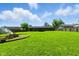 Expansive backyard with lush green lawn and a fire pit, perfect for outdoor gatherings at 9265 Brunson Run, Indianapolis, IN 46256