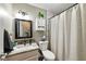 This cozy bathroom is adorned with a marble vanity, neutral tones, and decorative mirror at 9265 Brunson Run, Indianapolis, IN 46256