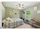 Cozy bedroom with neutral walls and decor, laminate floors, and a ceiling fan at 9265 Brunson Run, Indianapolis, IN 46256