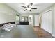 Bright bedroom with an ensuite bathroom, dark dresser, and wood-look laminate flooring at 9265 Brunson Run, Indianapolis, IN 46256