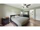 Comfortable bedroom featuring a ceiling fan, dark wood flooring and a modern dresser at 9265 Brunson Run, Indianapolis, IN 46256