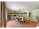 Relaxing dining room with a rustic wooden table, stone fireplace, and tile flooring at 9265 Brunson Run, Indianapolis, IN 46256