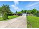Well-maintained home with a lush green lawn and long driveway on a sunny day at 9265 Brunson Run, Indianapolis, IN 46256