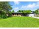 Charming single-story brick home with vibrant green lawn, and a yellow front door at 9265 Brunson Run, Indianapolis, IN 46256