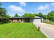 Charming single story brick home with a green lawn and an attached two car garage at 9265 Brunson Run, Indianapolis, IN 46256