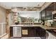 This open kitchen boasts granite countertops, stainless steel appliances, and dark cabinetry at 9265 Brunson Run, Indianapolis, IN 46256
