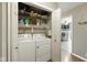 Practical laundry room featuring a washer and dryer with shelving for storage at 9265 Brunson Run, Indianapolis, IN 46256