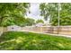 Spacious backyard featuring lush green grass, a wooden fence, and a detached garage at 946 N Temple Ave, Indianapolis, IN 46201
