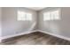 Light-filled bedroom featuring wood floors, base trim and neutral paint at 946 N Temple Ave, Indianapolis, IN 46201