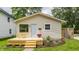 Charming home featuring a newly built deck with light blue door, and verdant landscaping at 946 N Temple Ave, Indianapolis, IN 46201