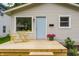 Charming home featuring a newly built deck with light blue door, landscaping and yellow cafe table at 946 N Temple Ave, Indianapolis, IN 46201