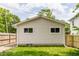 Exterior view of garage with two windows and a well-maintained lawn at 946 N Temple Ave, Indianapolis, IN 46201