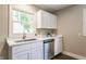 Bright kitchen with white cabinetry, stainless steel dishwasher and quartz countertops at 946 N Temple Ave, Indianapolis, IN 46201