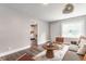 Bright living room features a comfy sofa, stylish decor, accent chairs, and plank flooring at 946 N Temple Ave, Indianapolis, IN 46201