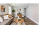 Bright living room features a comfy sofa, stylish decor, accent chairs, and plank flooring at 946 N Temple Ave, Indianapolis, IN 46201