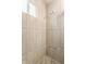 Neutral tile shower stall with rainfall shower head and window for natural light at 946 N Temple Ave, Indianapolis, IN 46201