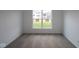 Bright, carpeted room with a large window and neutral walls providing a cozy space at 10604 Maidenhair Dr, Indianapolis, IN 46239