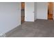 Cozy bedroom with neutral carpet, white walls, and doorway leading to other rooms at 10604 Maidenhair Dr, Indianapolis, IN 46239