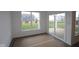 Bright sun room with large windows and sliding glass doors to the patio, ready for relaxation at 10604 Maidenhair Dr, Indianapolis, IN 46239