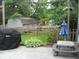 Private backyard featuring mature trees, lush landscaping, and outdoor patio furniture at 1067 Barley Cir, Carmel, IN 46032