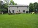 Large backyard featuring a well-maintained lawn, landscaping, and a playground set at 1067 Barley Cir, Carmel, IN 46032