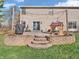 Backyard patio with stone steps, exterior lights, outdoor grill and playhouse at 1067 Barley Cir, Carmel, IN 46032