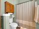 Cozy bathroom featuring a toilet, linen closet, and shower with decorative curtain at 1067 Barley Cir, Carmel, IN 46032