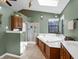 Bathroom featuring a soaking tub, walk-in shower, and ample natural light at 1067 Barley Cir, Carmel, IN 46032