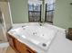 Bathroom showcasing a luxurious soaking tub with jets and a corner window at 1067 Barley Cir, Carmel, IN 46032