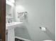 Clean bathroom featuring a pedestal sink and modern fixtures at 1067 Barley Cir, Carmel, IN 46032