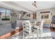 Open concept living and dining room with wood floors and a view of the Gathering room with gray sectional at 1067 Barley Cir, Carmel, IN 46032