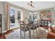 Inviting dining room with a charming table, chairs, french doors, a bright light fixture and a view to the backyard at 1067 Barley Cir, Carmel, IN 46032
