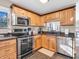 Bright kitchen featuring stainless steel appliances, granite countertops, and light wood cabinets at 1067 Barley Cir, Carmel, IN 46032