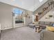 Bright living room featuring a large window, a comfortable sectional, and an open staircase with skylight at 1067 Barley Cir, Carmel, IN 46032