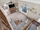 Open living room with vaulted ceiling, fireplace, large window, and comfortable grey sectional at 1067 Barley Cir, Carmel, IN 46032