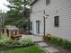 Inviting patio area with string lights, flowers, landscaping, and an outdoor playhouse at 1067 Barley Cir, Carmel, IN 46032