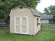A backyard shed featuring double doors, a window box, and white trim, surrounded by a grassy lawn at 1067 Barley Cir, Carmel, IN 46032