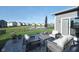 Beautiful backyard with patio furniture overlooking a pond, offering a serene outdoor living space at 11663 Winnower, Noblesville, IN 46060