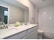 Bright bathroom featuring double sinks, white cabinets, quartz countertop, and tiled shower and bathtub at 11663 Winnower, Noblesville, IN 46060