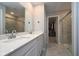 Modern bathroom features a double sink vanity and a glass-enclosed shower, offering a sleek and functional space at 11663 Winnower, Noblesville, IN 46060